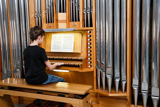 Photo of Boy playing pipe organ - classical music