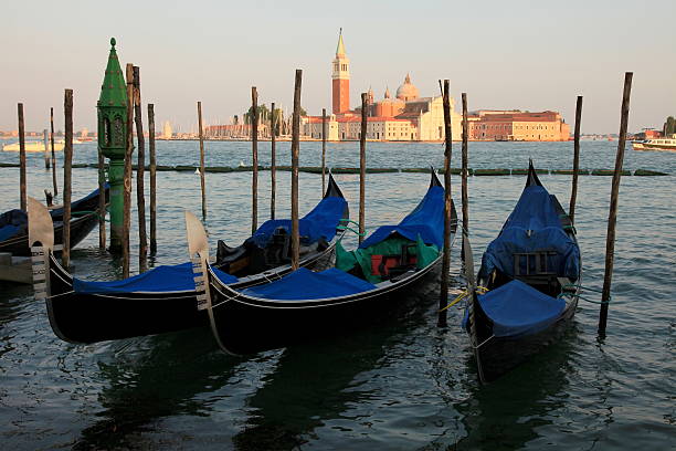 istock Gondolas anchored at sunset - Venice, Italy 180714567