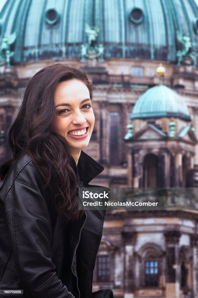 Young German beauty smiling in front of Berlin Cathedral Young German beauty smiling in front of Berlin Cathedral. She is wearing a leather jacket. Berlin Stock Photo