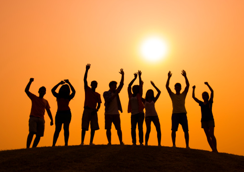 Group of people partying at sunset