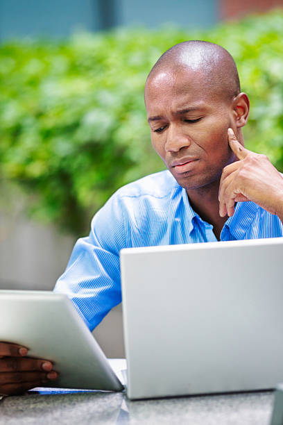 istock Pensive Businessman reading bad news on tablet 180715505