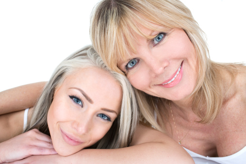close up of two beautiful women of different age groups isolated on white background