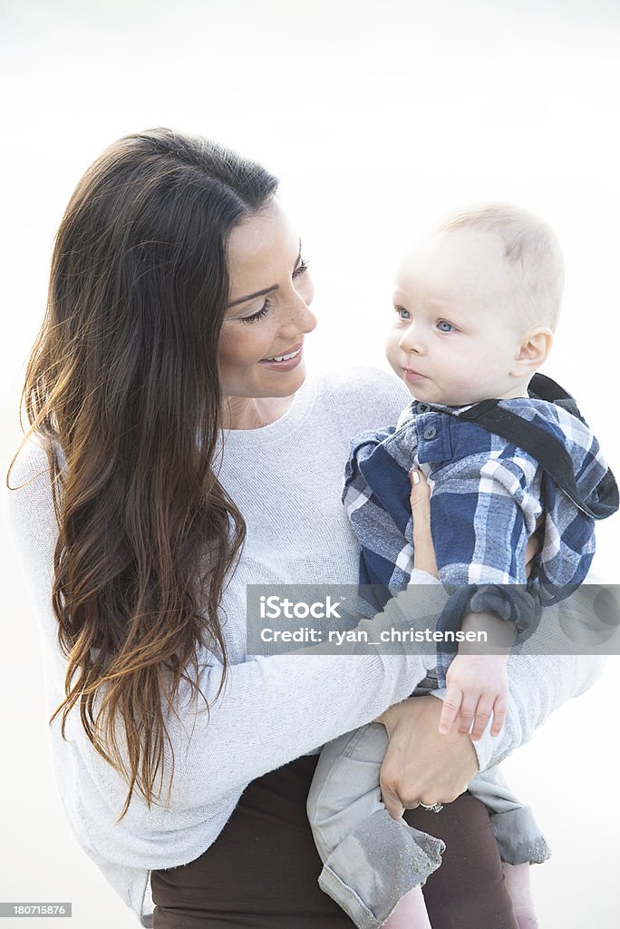 Lifestyles: Mother Loving Her Son Families: Mother holding her son as she looks at him with a big smile. Adult Stock Photo