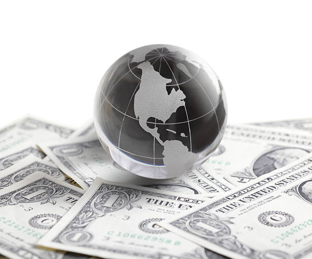 istock glass globe and money 180716617