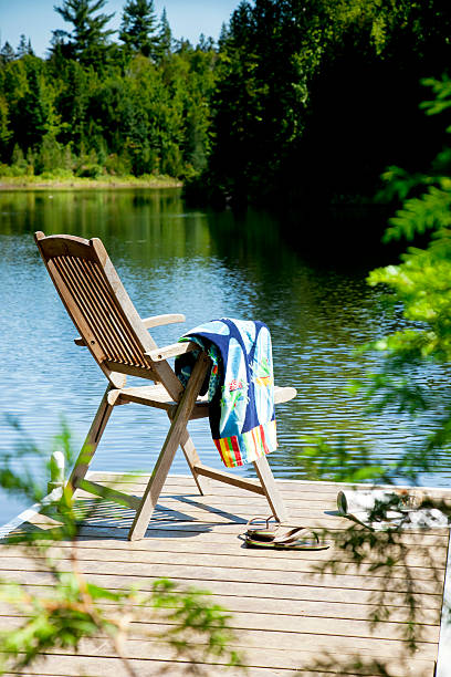 istock Deck chair and beach towel at lake. 180716832