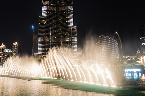 Water trick fountains in Dubai by night.