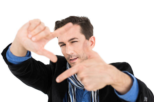Casual Man Finger Framing On White Casual man framing with fingers on something in front of him. determination focus the bigger picture human hand stock pictures, royalty-free photos & images