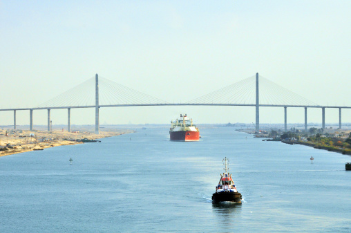 An LNG tanker passing through the Suez Canal Bridge with a pilot boat in the foreground. An LNG carrier is a tank ship designed for transporting liquefied natural gas (LNG).