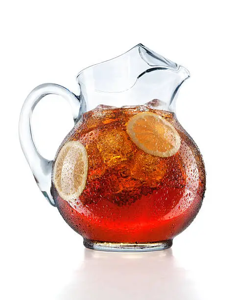 Pitcher of iced tea with lemon slices.