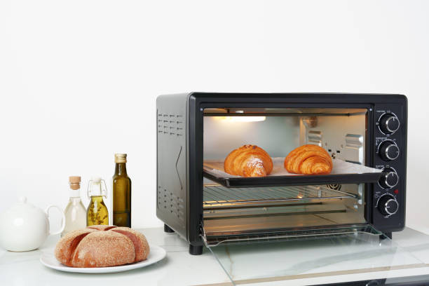 istock Modern mini electric oven with freshly baked croissants in kitchen 1807177521
