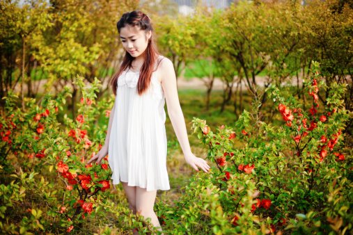 Young Chinese girl standing in the garden
