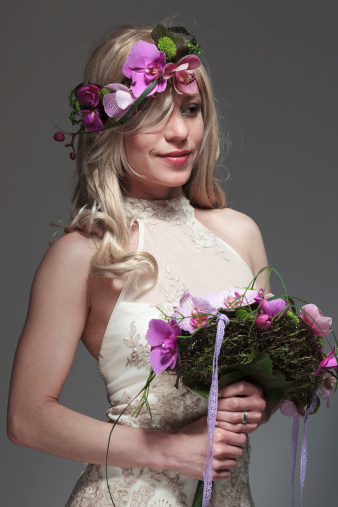 Bride holding an Orchids wedding bouquet. She has an Orchids flower crown in her head.
