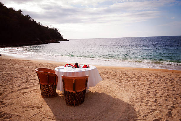 Romantic Beach Table Setting "A romantic table for two on Majahuitas Beach on the Bay of Banderas, near Puerto Vallarta, Mexico.All images in this series..." majahuitas beach stock pictures, royalty-free photos & images
