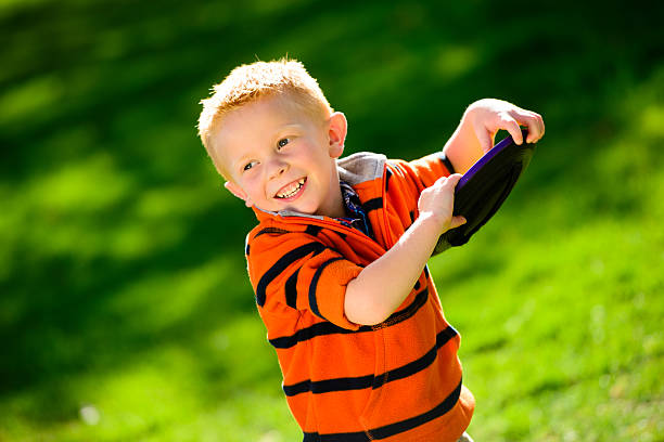 istock Preschool Boy Playing Frisbee 180718569