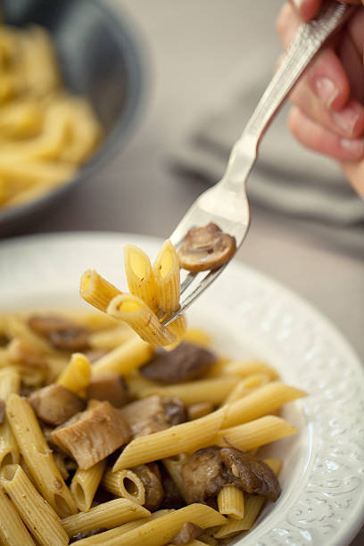 Pasta with Mushrooms Pasta with Mushrooms cooked selective focus vertical pasta stock pictures, royalty-free photos & images