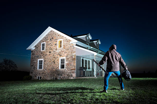 istock Burglar creeping up on a home 180718910