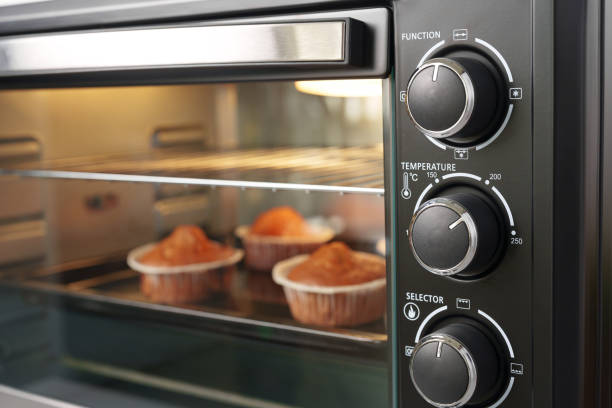 istock Electric mini oven and baked hot muffins close up 1807190021