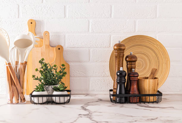 istock Set of kitchen utensils, various spice grinders on marble countertop in modern kitchen interior. Beautiful kitchen background. front view. 1807191995