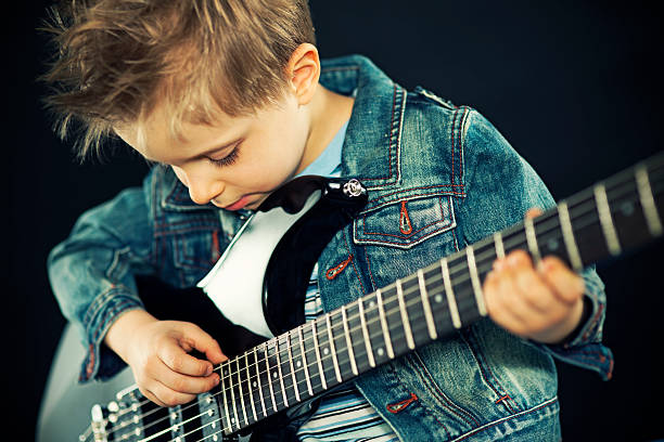 istock Little boy playing the guitar 180719467