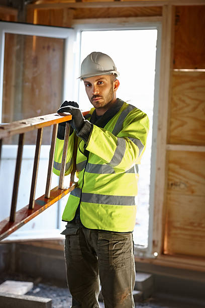 istock Male construction worker carrying a ladder 180719679
