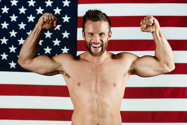 istock Man flexing his biceps in front of American flag 180719732