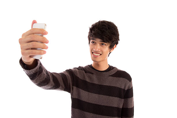 istock Young man in a striped sweater taking a selfie  180720243