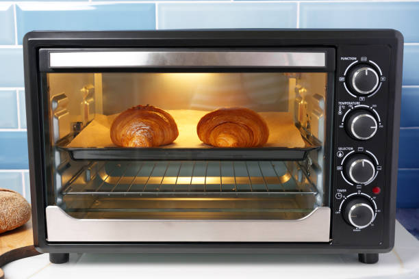istock Modern mini electric oven with freshly baked croissants in kitchen 1807206378