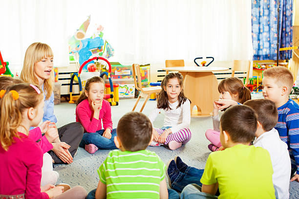istock Teacher discussing with children. 180720894