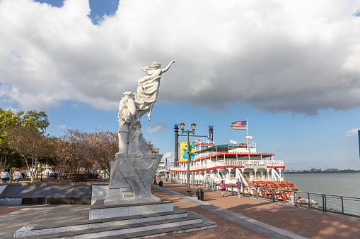 New Orleans, USA - October 24, 2023: Steamboat city of new orleans at the pier  at Mississippi River near the Monument To The Immigrant. The steamboat is still in Operation for touristic events.