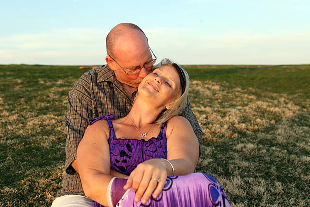 istock Middle Aged couple enjoying a Sunset. 180721178