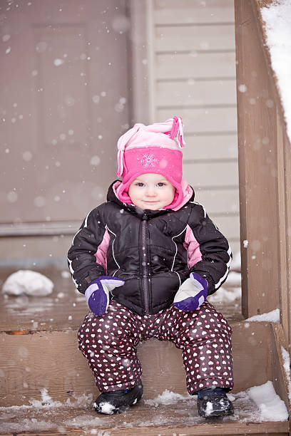istock Girl Sitting on Front Step in Snow 180721692