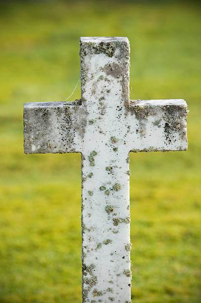 A damaged graveyard cross. Grunge feel.