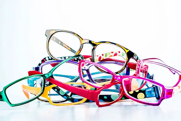 Many pairs of brightly colored eyeglasses