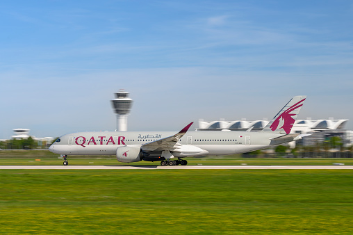 Munich, Germany - September 02. 2023 : Qatar Airways Airbus A350-941 with the aircraft registration A7-AMJ is starting on the southern runway 26L of the Munich airport MUC EDDM