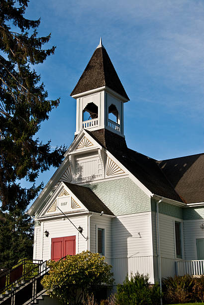 Burton Community Church (1897) The First Baptist Church of Burton was built in 1897 on land acquired by a land grant. In 1928, the church was reorganized and renamed the Burton Community Church. This more accurately reflected the diverse religious backgrounds of the member. Burton Community Church is located on Vashon Island in Burton, Washington State, USA. jeff goulden puget sound stock pictures, royalty-free photos & images