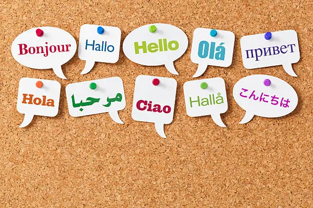 Photo of Hello in ten different languages on white speech bubbles