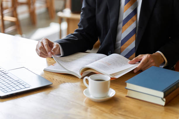 istock Asian businessman reading at a cafe to study 1807227388