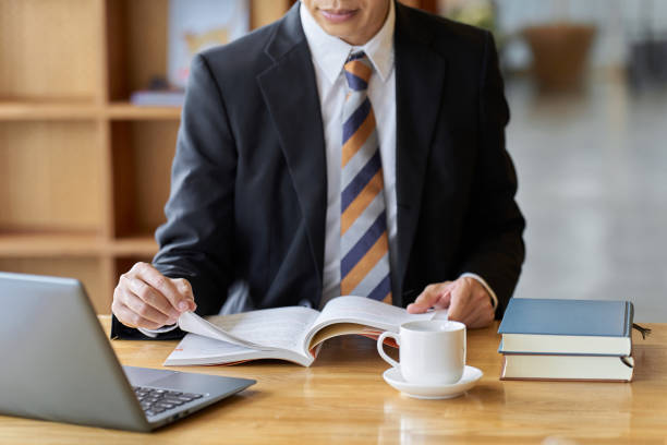 istock Asian businessman reading at a cafe to study 1807227920
