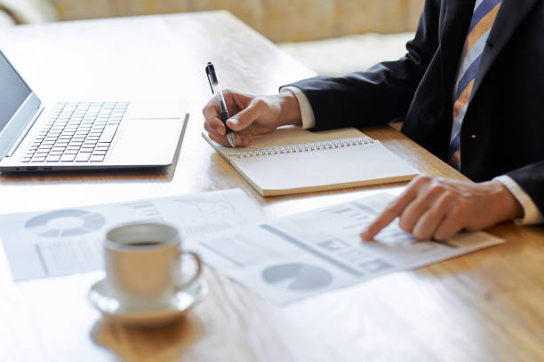 istock Hands of an Asian businessman analyzing data at a cafe 1807228965