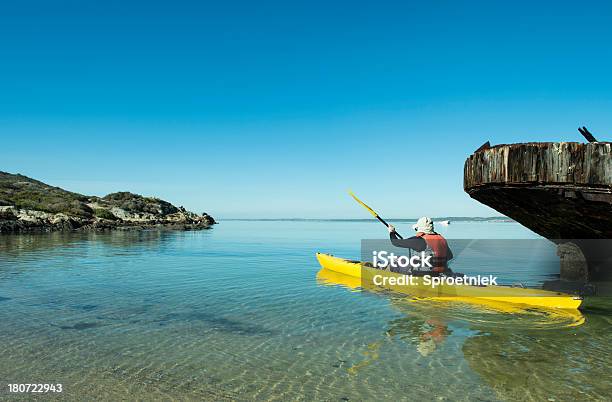 Kayaker Paddling Out Into Langebaan Lagoon Stock Photo - Download Image Now - 60-69 Years, Active Lifestyle, Active Seniors