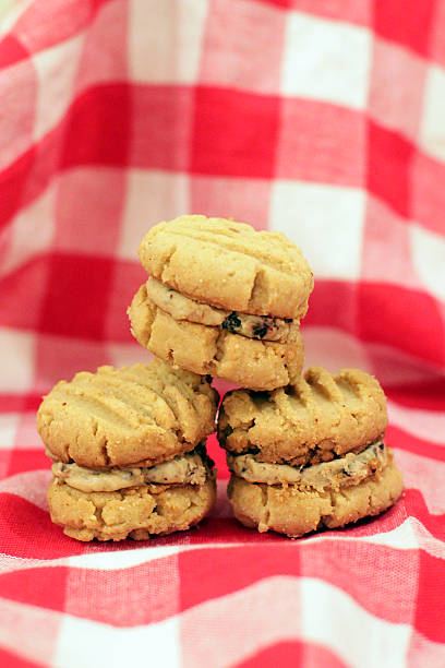 istock Peanut Butter Sandwich Cookies on Checked Tablecloth 180723054
