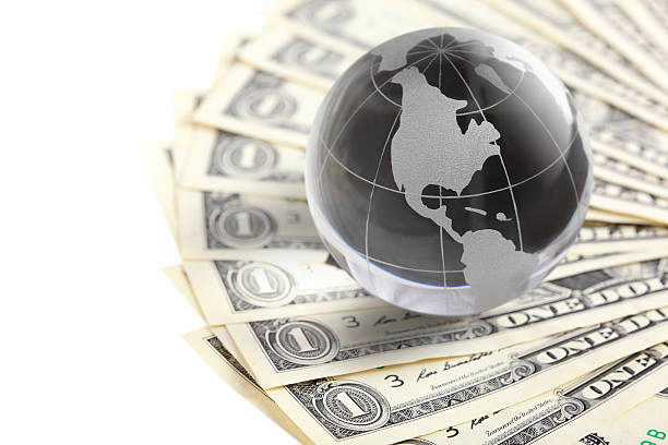 istock glass globe and money 180723338