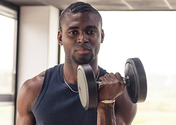 istock serious african man with dumbbell 180723368