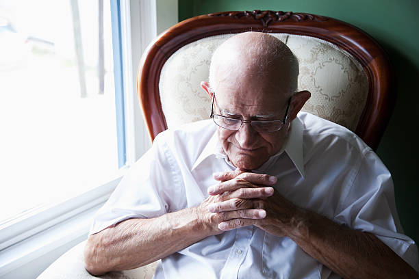 istock Senior man with eyes closed and hands clasped 180723388