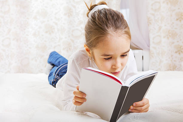 istock Beautiful little girl reading 180723547