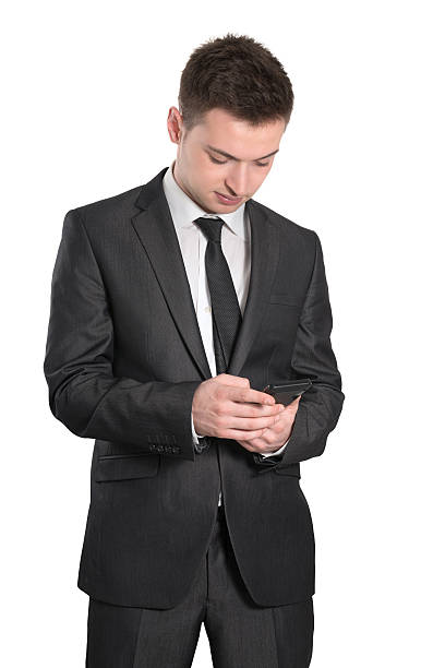 istock Young Handsome and Confident Businessman Texting on Smart Phone 180723654