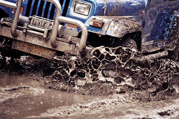 Border Track, Australia - March 13, 2011: Red 2007 Rubicon Jeep JK Wrangler stuck in mud on the border track between South Australia and Victoria. This Jeep is being recovered by using a snatch / tow strap