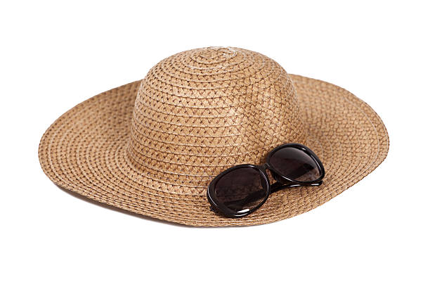 A beach hat and sunglasses isolated on a white background.