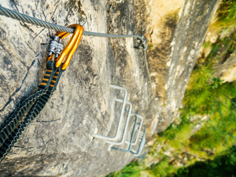 Carabiners secured to a safety rope on a via ferrata (klettersteig)