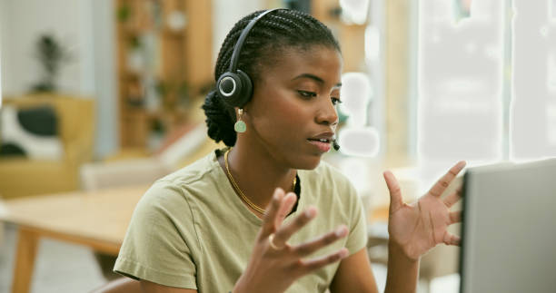 istock Woman, home and call center communication, customer service or e commerce support on a computer. African consultant or worker in telemarketing, virtual advice or helping online with questions or FAQ 1807241479